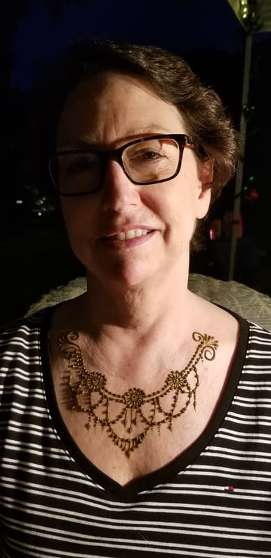 Henna necklace design draped across a woman's collarbone
